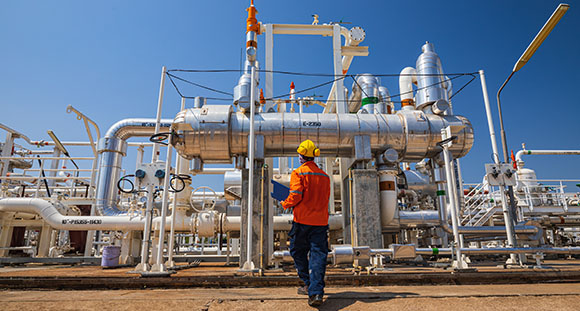 a worker walking over to a gas installation to check it